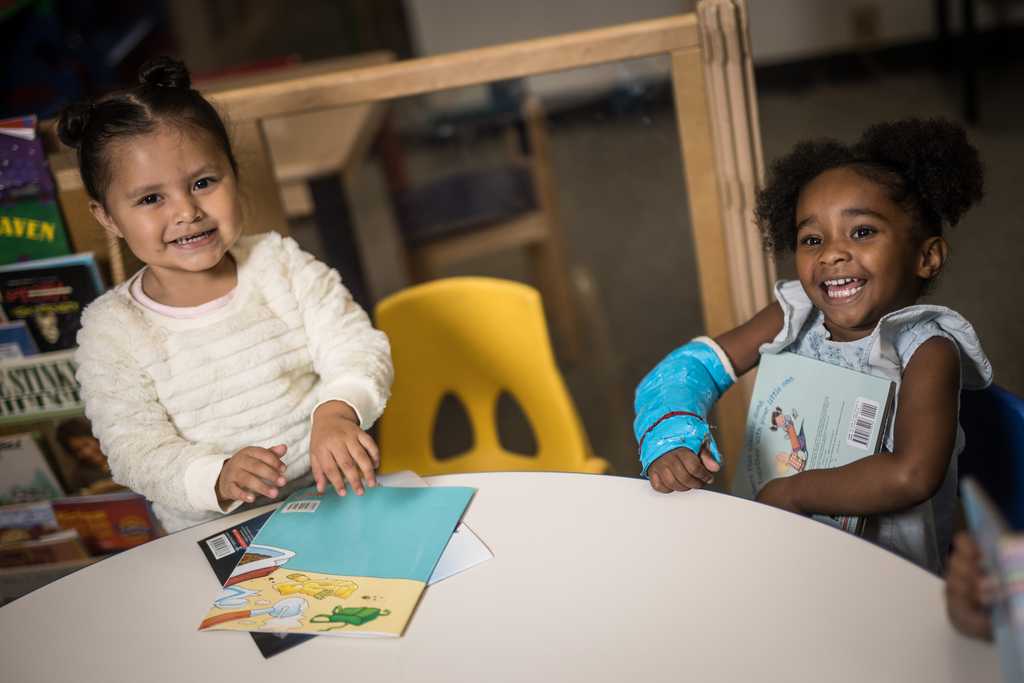 Two children smiling in a classroom