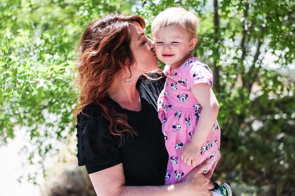 Mother kissing her toddler on the cheek